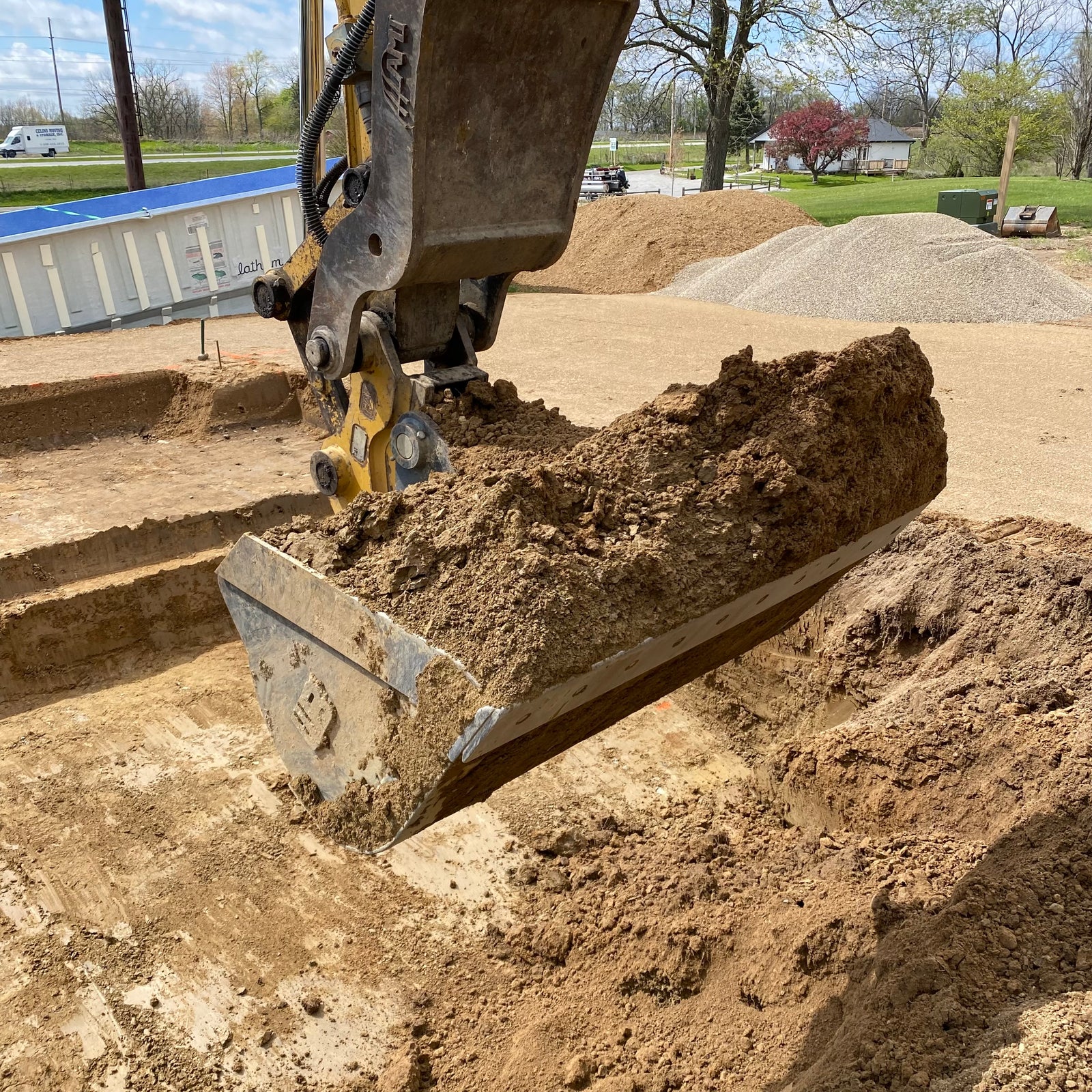 excavator digging a hole for the pool