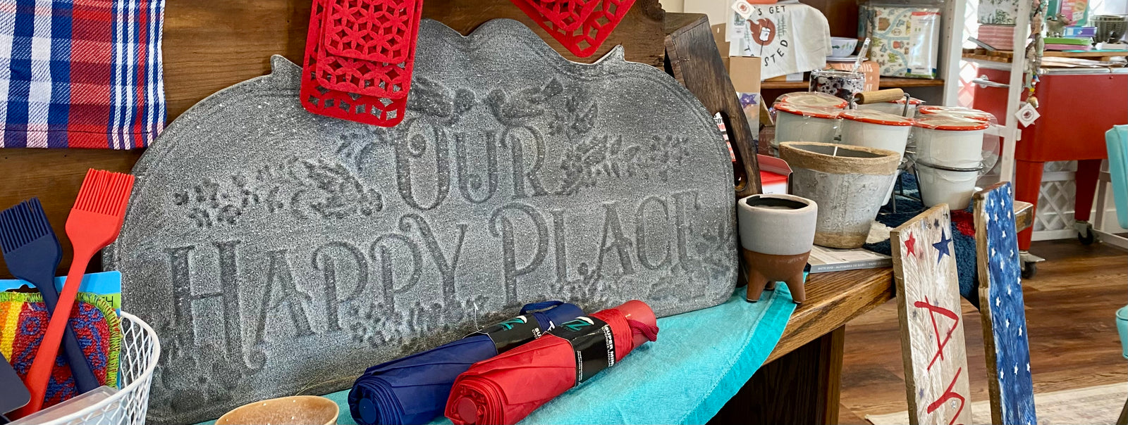 image of store items with a sign that says "our happy place"