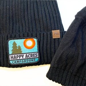 black knit lined beanie hat with happy acres patch and lining